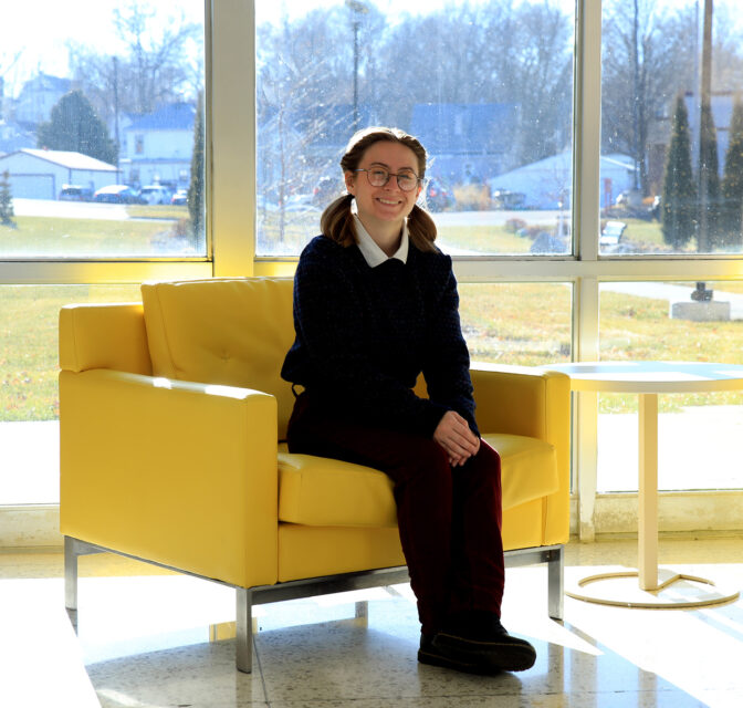 Claire Conn poses in the Eppley Auditorium lobby