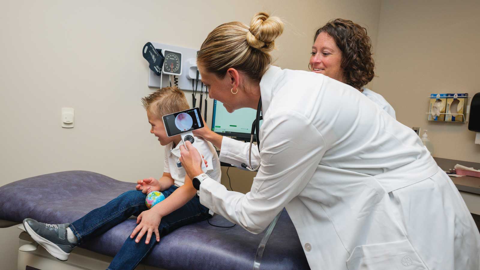 two doctors with child patient