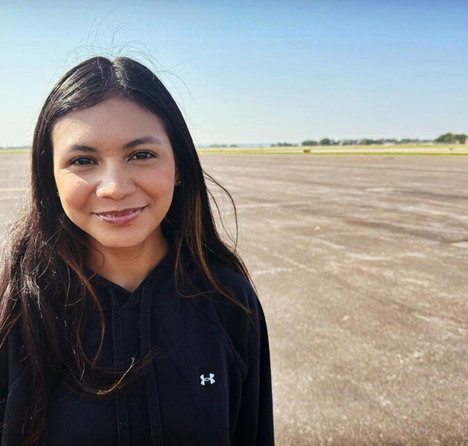 Valerie Mejia poses for a picture out at the Sioux City airport