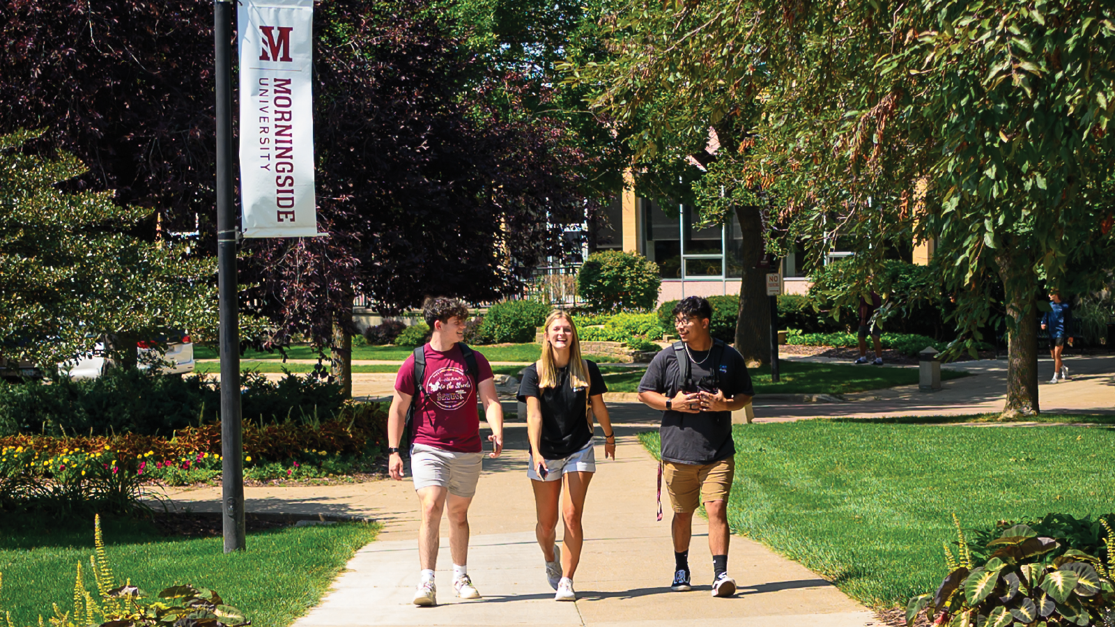 three students walking on campus